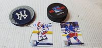 Front view showing Yankees keychain, Rangers puck front, Grabner and Miller cards front