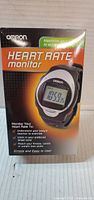 Front of sealed Omron HR-100C heart rate monitor retail box