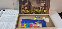 Open box showing board, pieces, cards