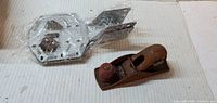Block hand plane next to wrapped steel brackets