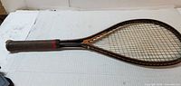 Full view of racquet front side showing frame and strings