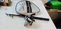 Full view of telescoping rod with reel attached and case