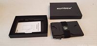 Wallet, instruction card and box shown closed