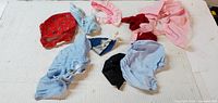 All nine doll garments laid out for overview