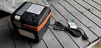 Side view of cube heater showing orange handle, power cord and general wear