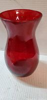 Front view of tall red glass vase