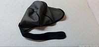 Gray neoprene swim cap with chin strap displayed flat