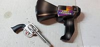 Megaphone and toy revolver side by side