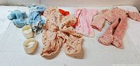 All doll clothing pieces laid out