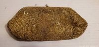 Front of gold beaded purse showing concentric bead pattern