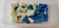 Tray of white and blue carved stone chess pieces, view from above
