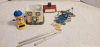 All items overview: ceramic house, chime tubes, blue ornament, snowman