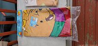 Packaged Winnie the Pooh flag with green scarf design