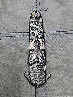 Handle side closed showing etched knight artwork