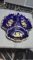 Top view of cobalt blue porcelain divided dish with gold floral decoration