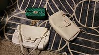 Top view of all three handbags on rug