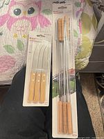 Both unopened packages showing knives and skewers