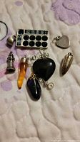 Group shot of all seven pendants and charms