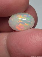 Front view of oval Ethiopian opal showing multicolor play-of-color