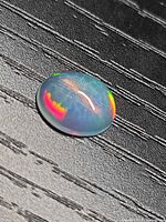 Front view of oval opal showing honeycomb pattern and play-of-colour