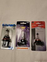 Front view of all three packaged bulbs: Sylvania 9005, Certified 9007, RoadPro H1155