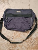 Front view of Jaguar navy messenger bag showing overall design, strap and exterior pocket