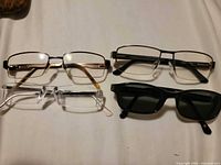 Four eyewear frames laid flat showing overall styles and colors
