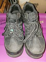 Front view of both shoes showing laces, brand on tongue, overall wear