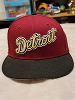 Front view showing Detroit script embroidery, crown and visor colors