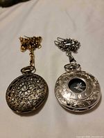 Front view of closed gold and silver pocket watches showing case designs