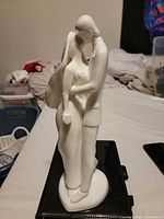 Side view of full porcelain figurine on base