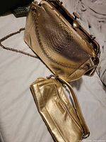 Both gold bags together for size and style comparison