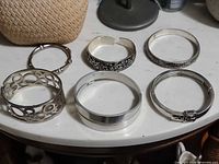 All six silver-plated bracelets displayed