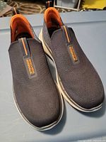 Top three-quarter view of both shoes showing uppers, pull tabs, logos, and overall condition