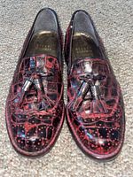 Top view of both loafers showing overall style, color, tassels and brand stamp