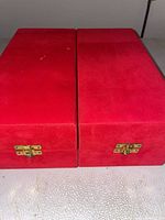 Closed red presentation boxes with brass latches