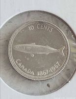 Reverse of 1867-1967 10 cents coin showing mackerel and legends