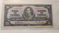 Obverse showing portrait of King George VI, serial number and signatures