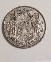 Reverse side showing denomination 50 CENTS, coat of arms, CANADA 1951
