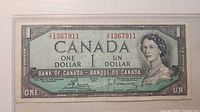Obverse of 1954 $1 banknote showing portrait, denomination, serial number 1367911