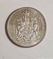 Reverse side showing Canadian coat of arms and denomination