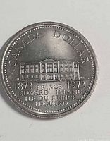 Reverse of 1973 PEI Centennial dollar showing Province House design and inscriptions