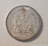 Reverse of 1959 Canadian 50-cent coin showing Canadian coat of arms and date