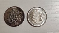 Both 1966 Canada 50-cent coins reverse side showing coat of arms and date