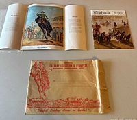 Programme laid open with loose prints and envelope visible