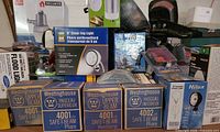 Stack of boxed headlamps, fog light, various packaged lights