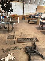 Overall lot showing windmill tower, bench parts, signs on floor