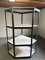 Full view of shelving unit angled to show corner shape and all shelves