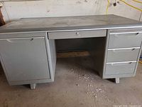 Front view showing overall desk layout, cabinet left, center drawer, right drawers