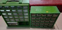 front view of two green organizer cabinets showing drawers and contents